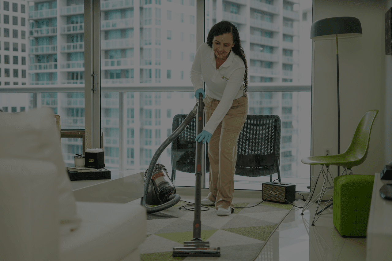 cleaning lady with vacuum cleaning apartment